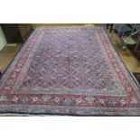 A FINE HERATI WOOL RUG the indigo and wine ground with central panel filled with stylized