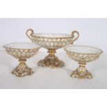 A SUITE OF THREE CONTINENTAL CHINA COMPORTS the white and gilt ground with pierced decoration on a