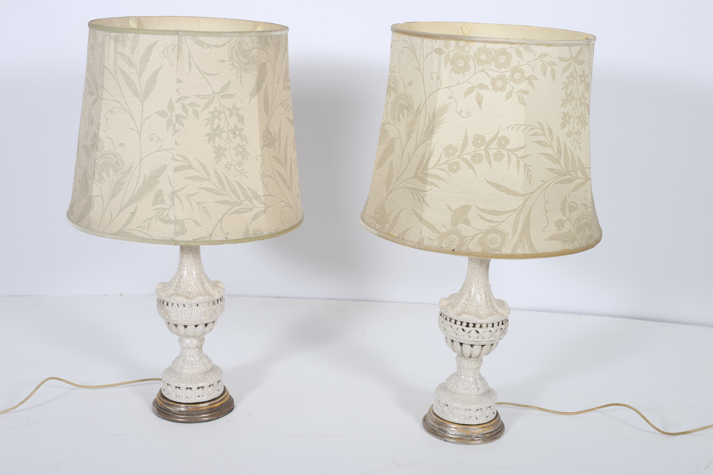 A PAIR OF CONTINENTAL PORCELAIN TABLE LAMPS each of baluster form a silvered base with shades 77cm