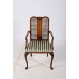 A WALNUT ELBOW CHAIR CIRCA 1950s with caned back and upholstered seat with shepherd crooked arms on