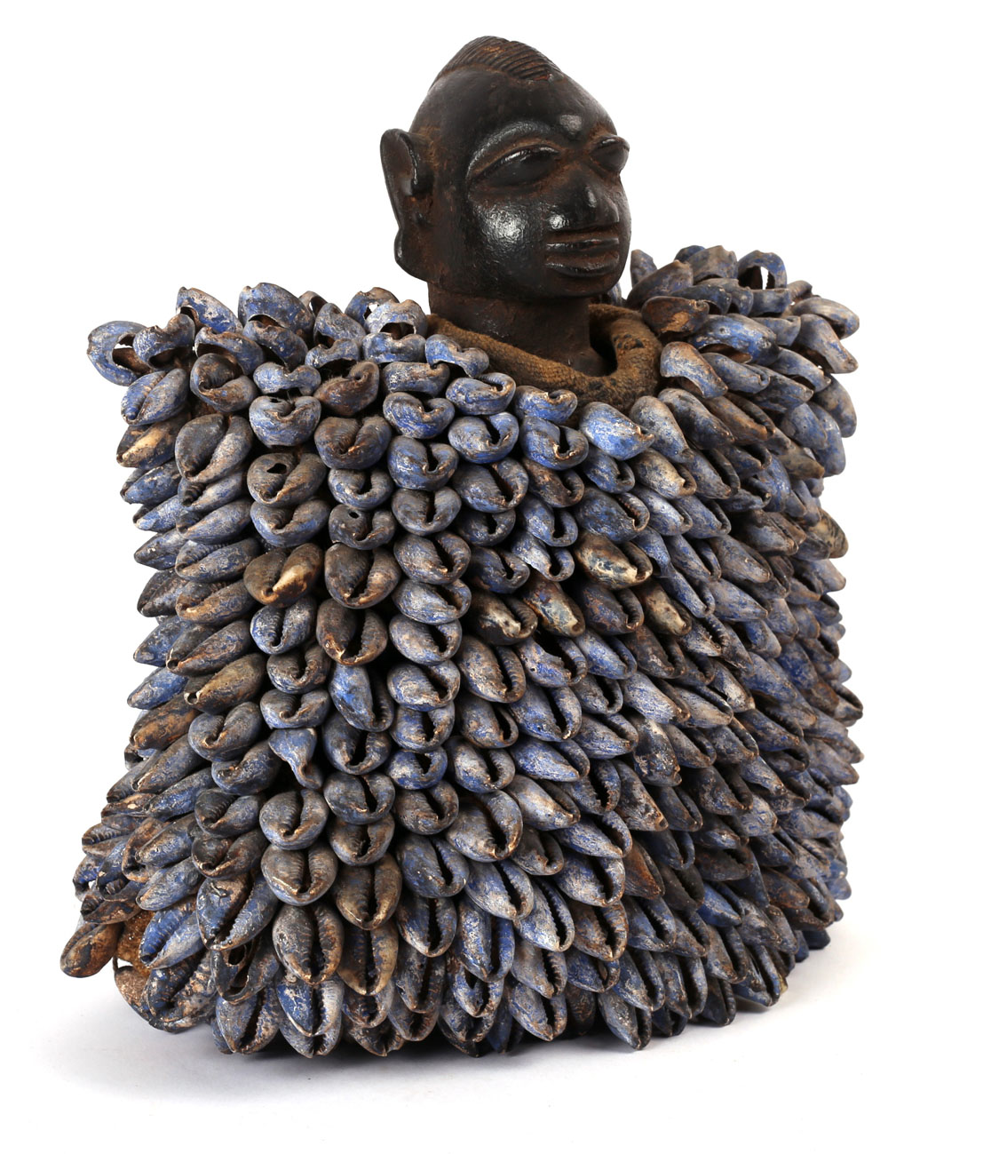 Tribal Art. A mid-20th century Yoruba Ibeji, a carved wood male figure with cowrie shell cloak.