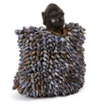 Tribal Art. A mid-20th century Yoruba Ibeji, a carved wood male figure with cowrie shell cloak.