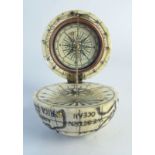 A scrimshaw style globe compass, the globe naively mapped,