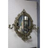 A FINE BRASS GIRANDOLE MIRROR the oval plate within a flowerhead and foliate pierced frame with