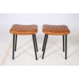 A PAIR OF RETRO HIDE UPHOLSTERED AND BLACK METAL LOW STOOLS each with a rectangular seat with