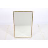 A GILT BRASS FRAMED MIRROR the rectangular bevelled glass plate within a ring turned frame 56cm x