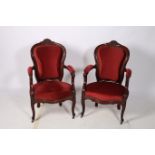 A FINE PAIR OF 19TH CENTURY CARVED MAHOGANY ELBOW CHAIRS each with a foliate and flowerhead