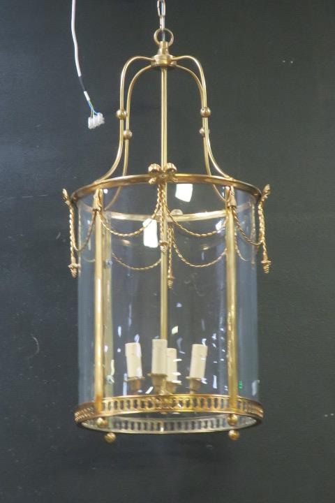 A GILT BRASS AND GLAZED FOUR LIGHT HALL LANTERN of circular form with pierced circlet hung with