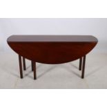 A GEORGIAN MAHOGANY DROP LEAF TABLE the oval hinged top raised on square moulded legs 72cm (h) x