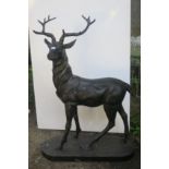 A CAST IRON FIGURE modelled as a stag shown standing on an oval base 147cm (h) x 102cm (w) x 42cm