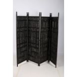 A BERNESE HARDWOOD CARVED FOUR FOLD SCREEN each panel with pierced foliate decoration 179cm x 224cm