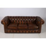 A VICTORIAN DESIGN BROWN BUTTON UPHOLSTERED BED SETTEE with scroll over back and arms and loose