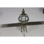 A GILT METAL AND GLAZED CANDLE HOLDER of ovoid form raised on tripod support 100cm (h)