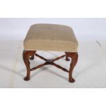 A GEORGIAN DESIGN MAHOGANY AND UPHOLSTERED STOOL the rectangular upholstered seat raised on