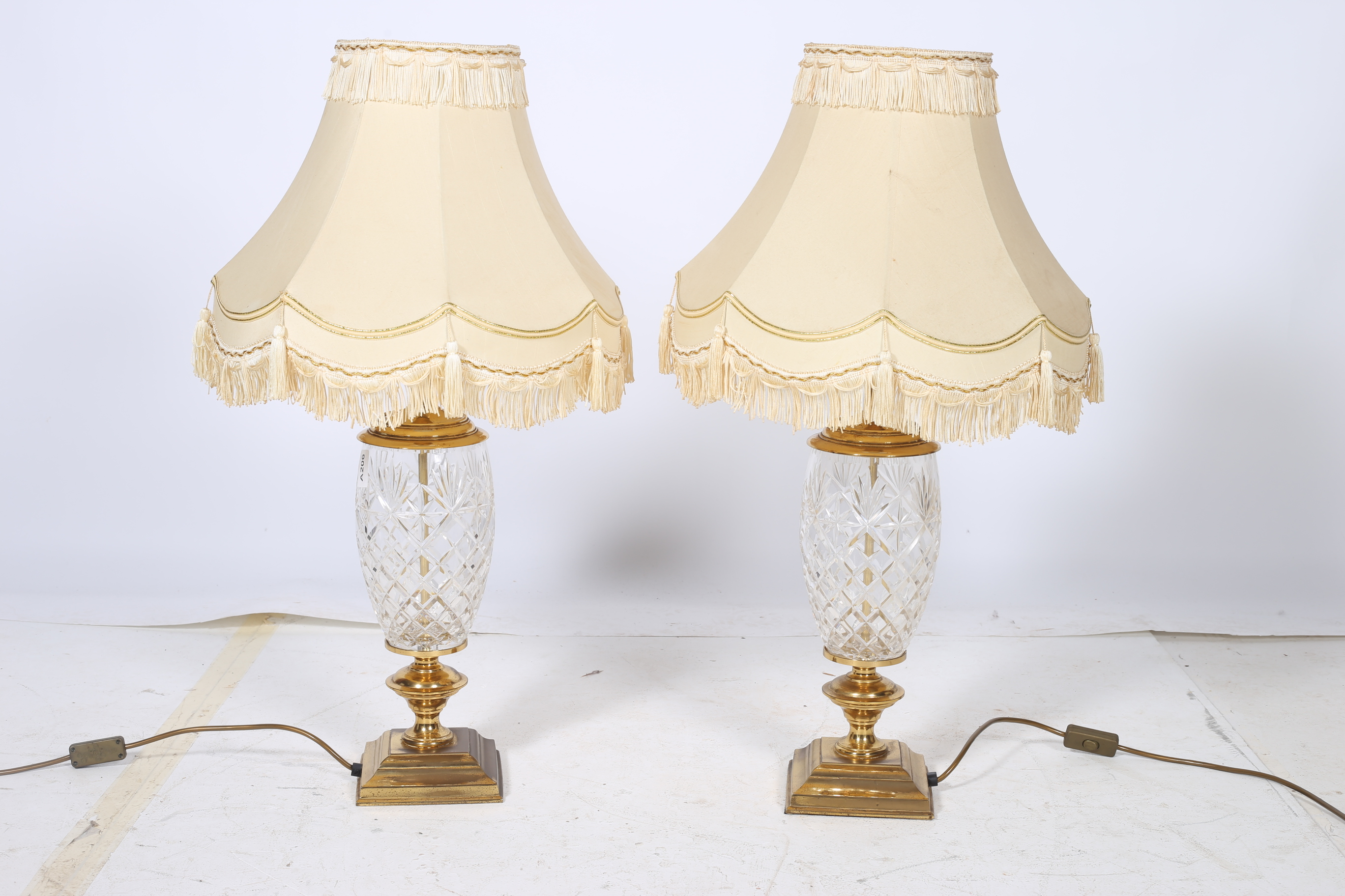 A PAIR OF CONTINENTAL CUT GLASS AND BRASS TABLE LAMPS each with an ovoid cut glass bowl above a