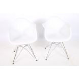 A PAIR OF DESIGNER WHITE POLYPROPYLENE AND WHITE METAL TUB SHAPED CHAIRS on tubular legs