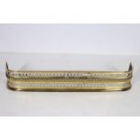 A 19TH CENTURY BRASS FENDER with pierced and roped frieze on stepped base 18cm (h) x 115cm (w) x