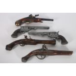 A 19TH CENTURY MIDDLE EASTERN FLINTLOCK PISTOL with gilt inlaid stock together with a group of four