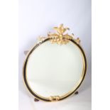 A CONTINENTAL GILTWOOD GESSO AND EBONISED MIRROR the circular bevelled glass plate within a moulded
