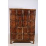 AN ORIENTAL HARDWOOD AND BRASS BOUND PANELLED CUPBOARD of rectangular outline with panelled doors