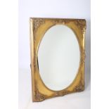 A CONTINENTAL GILTWOOD AND GESSO MIRROR the oval plate within a flowerhead and foliate embossed