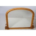 A VICTORIAN DESIGN GILT FRAME MIRROR the rectangular arched plate within a flowerhead and foliate