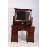 AN ART NOUVEAU MAHOGANY DRESSING TABLE the superstructure with bevelled glass mirror above a