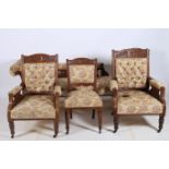 AN EDWARDIAN CARVED OAK AND UPHOLSTERED SEVEN PIECE DRAWING ROOM SUITE comprising set of four