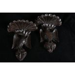 A PAIR OF 19TH CENTURY BLACK FOREST CARVED OAK WALL BRACKETS each with a foliate carved shelf above