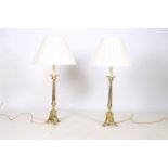 A GOOD HEAVY PAIR OF BRASS TABLE LAMPS each with a reeded column above a triform base with claw
