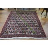 A PERSIAN HANDMADE WOOL RUG the white rust and indigo ground with central panel filled with