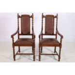A PAIR OF CIRCA 1950s OAK ELBOW CHAIRS each with upholstered panelled back and seat with spiral