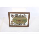 AN IRISH WHISKEY ADVERTISEMENT MIRROR inscribed Old Bushmills Irish Whiskey in hardwood frame 34cm