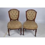 A PAIR OF 19TH CENTURY SATINWOOD SIDE CHAIRS each with an arched top rail and button upholstered