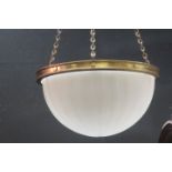 A RETRO OPALINE AND BRASS CEILING SHADE of dome form with brass circlet and chain suspension with