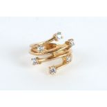 A 9ct GOLD SIX STONE DIAMOND CROSS OVER DRESS RING