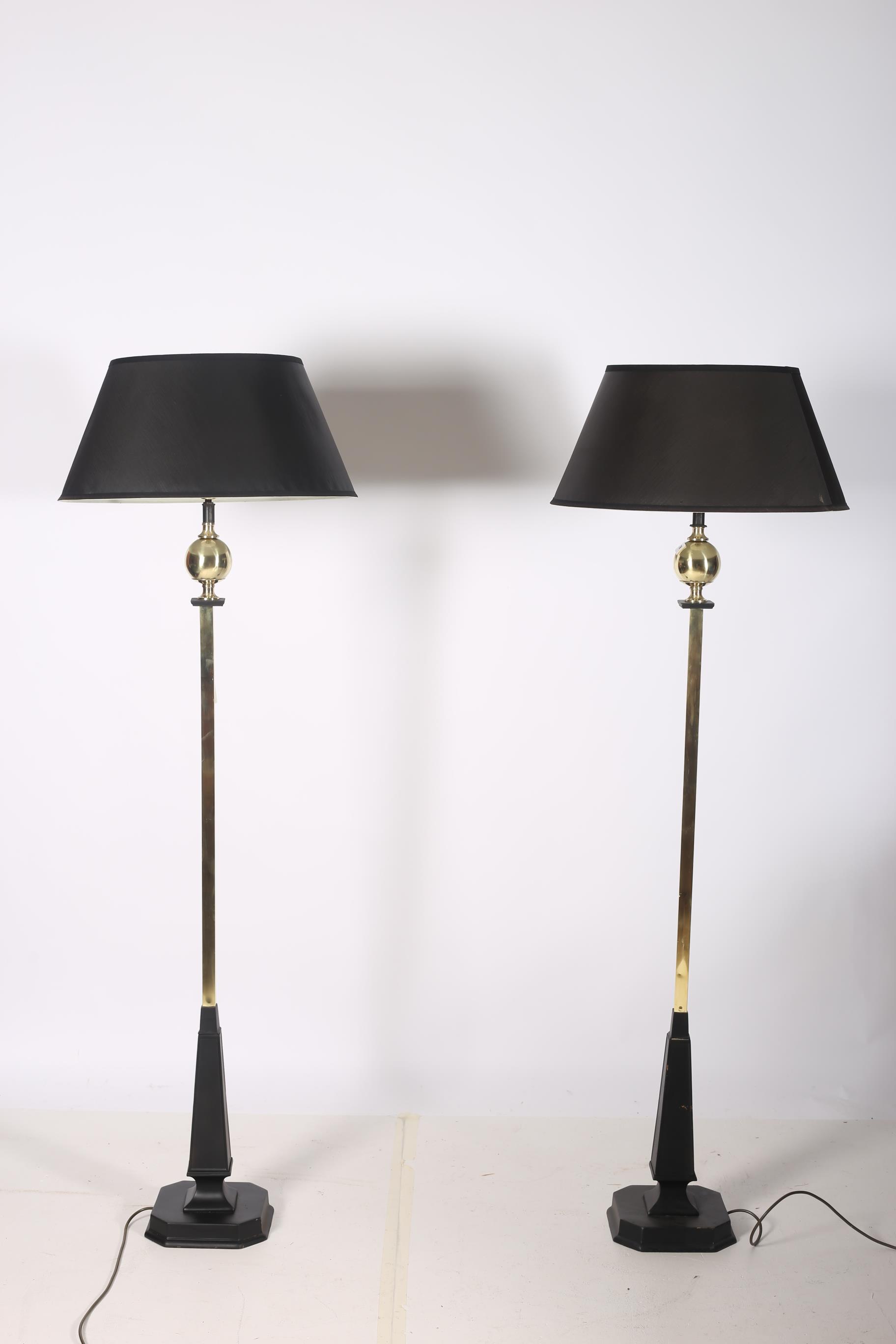 A PAIR OF BRASS AND STEEL FLOOR STANDARD LAMPS each with a rectangular spreading column with