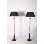 A PAIR OF BRASS AND STEEL FLOOR STANDARD LAMPS each with a rectangular spreading column with