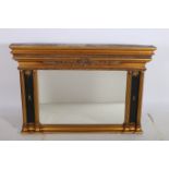 A REGENCY DESIGN GILTWOOD GESSO AND EBONISED OVERMANTLE MIRROR the moulded cornice with shell and