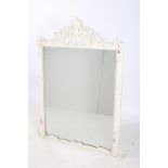 A 19TH CENTURY PINE AND WHITE PAINTED MIRROR the rectangular plate within a foliate carved frame