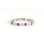 AN 18CT WHITE GOLD RUBY AND DIAMOND FULL ETERNITY DRESS RING