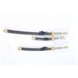 A SET OF THREE JAPANESE SAMURAI STYLE SWORDS with simulated ivory hilt in gilt metal mounted