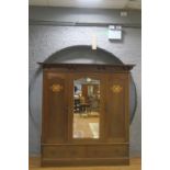 AN ART NOUVEAU MAHOGANY INLAID TWO DOOR WARDROBE the moulded cornice above a central bevelled glass