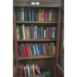 A COLLECTION OF VARIOUS HARDBACK BOOKS on four shelves