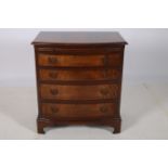 A GEORGIAN DESIGN MAHOGANY CROSS BANDED CHEST of demilune outline the shaped top above a brush and