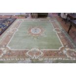 AN INDIAN WOOL RUG the light green pink and cream ground with central panel filled with flowerheads