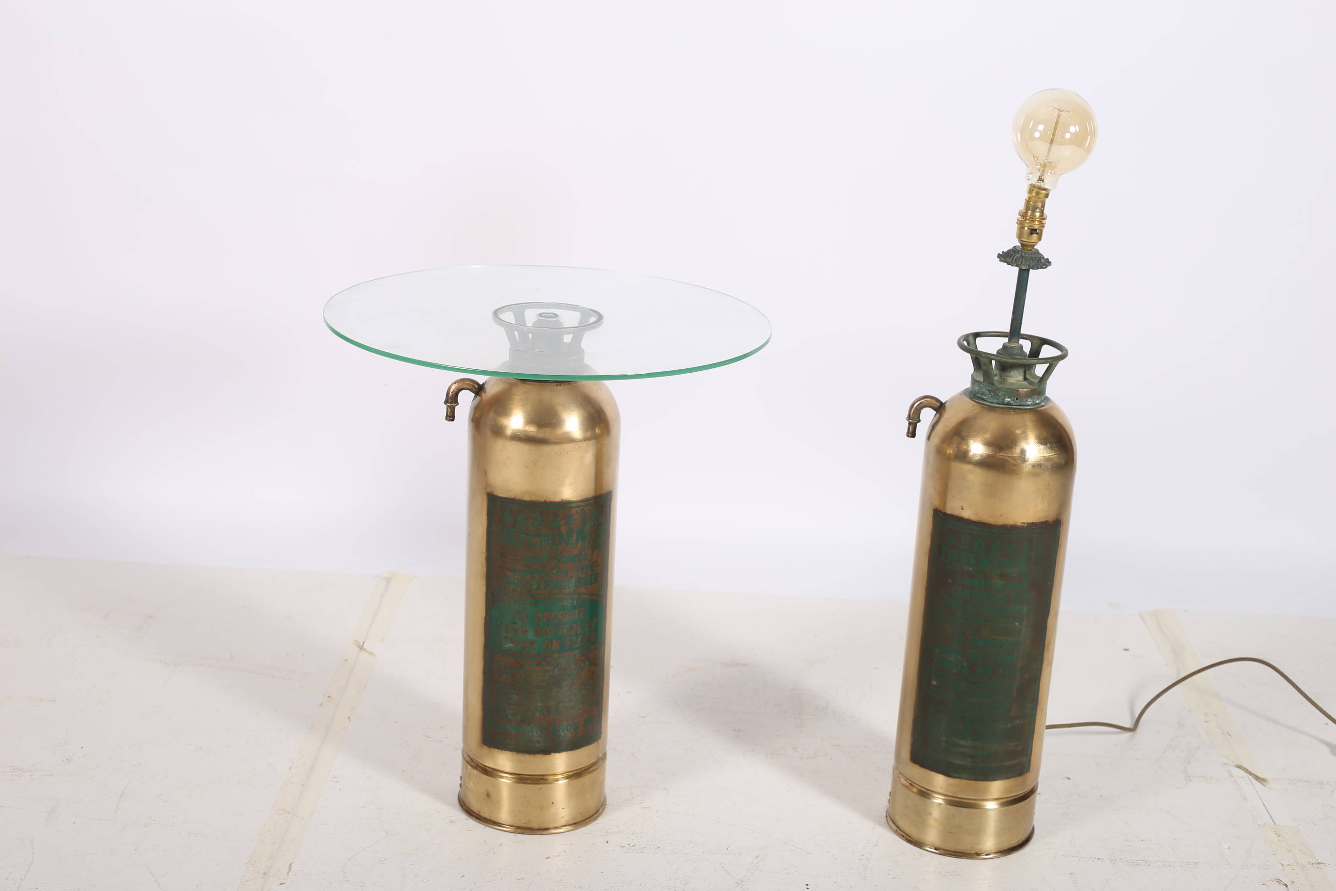 A VINTAGE BRASS TABLE LAMP in the form of a fire extinguisher 91cm (h) together with a vintage