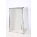 A CONTINENTAL SILVER FRAMED MIRROR the rectangular plate between canted angles with mirrored panels