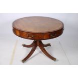 A 19TH CENTURY MAHOGANY AND ROSEWOOD CROSS BANDED DRUM TABLE the circular top with tooled leather