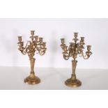 A PAIR OF CONTINENTAL GILT BRASS SEVEN BRANCH CANDELABRAS hung in two registers with foliate cast